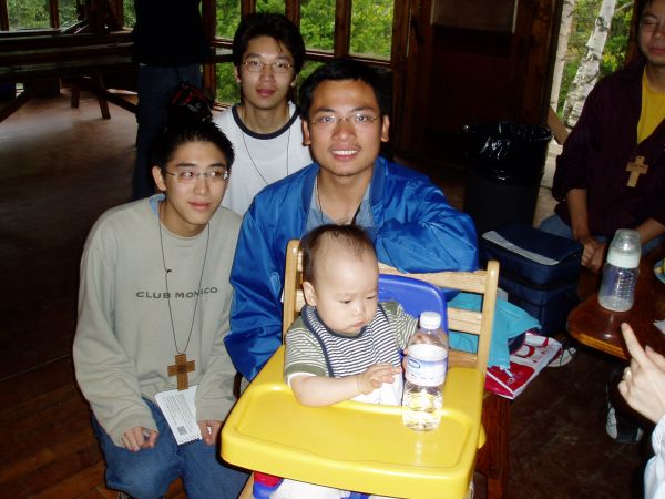 Taking a picture with the baby...ah so cute! James is still hungry, he is looking at the baby food.