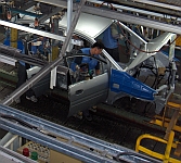 Workers assemble a van at a Hyundai assembly line